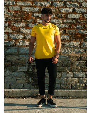 Model wears 4GAINS unisex t-shirt in yellow/black